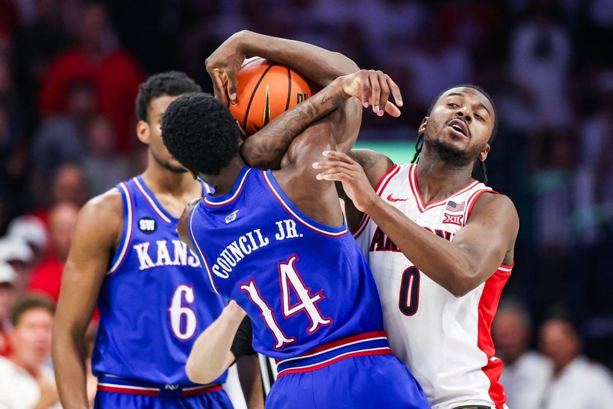 Feb 28, 2026; Tucson, Arizona, USA; Arizona Wildcats guard Jaden Bradley (0) attempts to take the ball from Kansas Jayhawks guard Melvin Council Jr. (14) during the second half of the game at McKale Memorial Center. Mandatory Credit: Aryanna Frank-Imagn Images