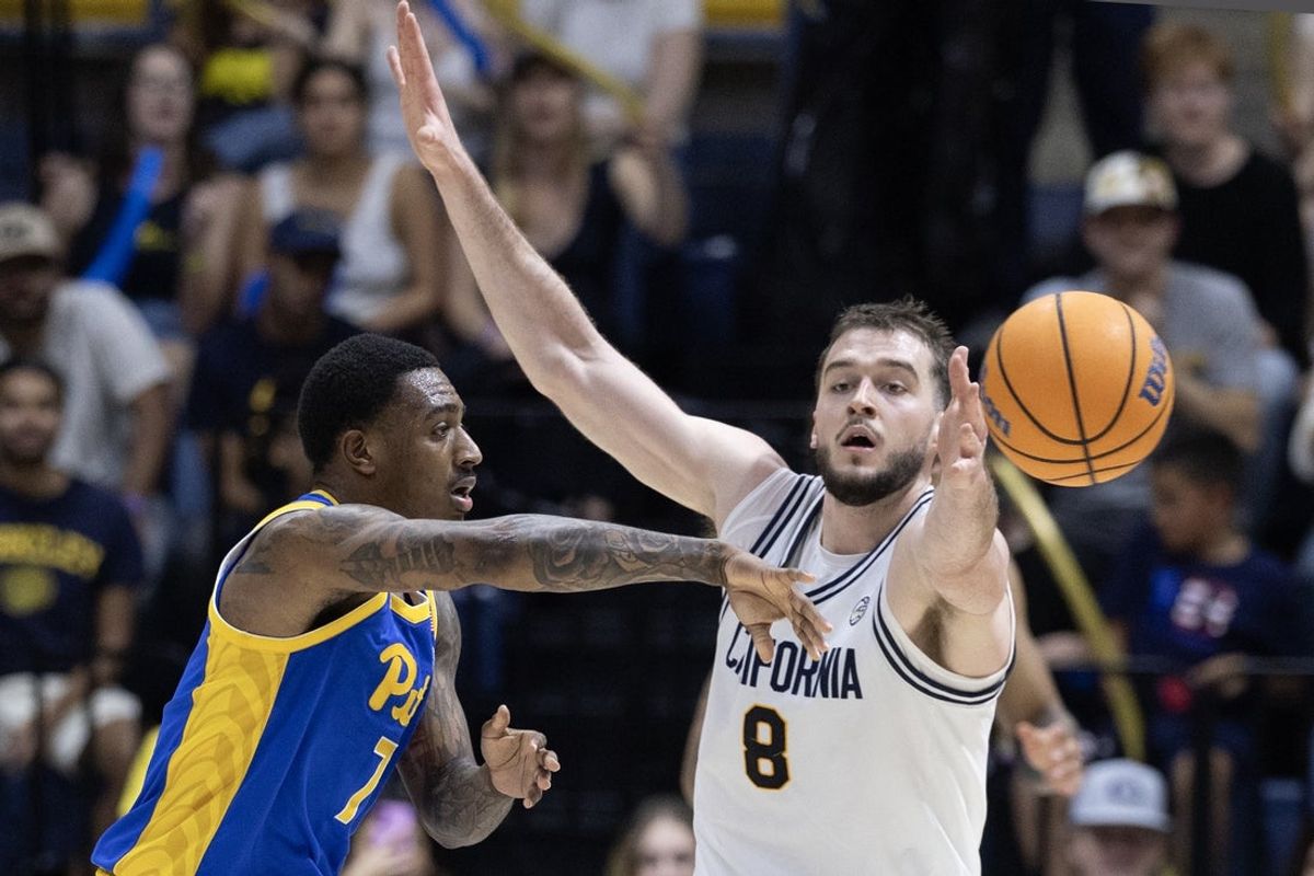 Feb 28, 2026; Berkeley, California, USA; Pittsburgh Panthers guard Damarco Minor (7) passes around California Golden Bears center Milos Ilic (8) during the second half at Haas Pavilion. Mandatory Credit: D. Ross Cameron-Imagn Images