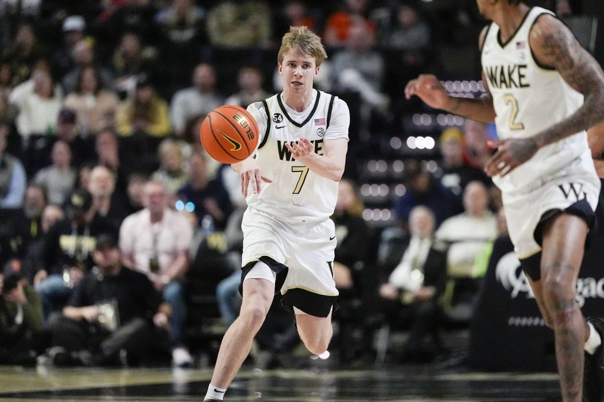 Feb 28, 2026; Winston-Salem, North Carolina, USA; Wake Forest Demon Deacons guard Isaac Carr (7) passes the ball to forward Juke Harris (2) during the first half against the Syracuse Orange at Lawrence Joel Veterans Memorial Coliseum. Mandatory Credit: Jim Dedmon-Imagn Images