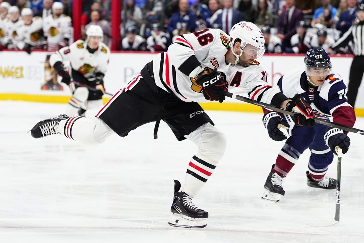Feb 28, 2026; Denver, Colorado, USA; Chicago Blackhawks center Jason Dickinson (16) takes a shot on the net of the Colorado Avalanche during the first period at Ball Arena. Mandatory Credit: Ron Chenoy-Imagn Images