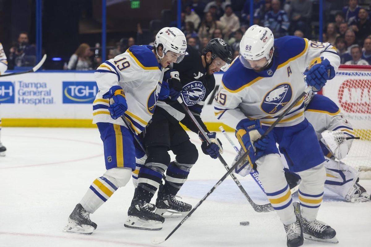 Feb 28, 2026; Tampa, Florida, USA; Buffalo Sabres forward Peyton Krebs (19), forward Alex Tuch (89) and Tampa Bay Lightning forward Anthony Cirelli (71) battle for the puck during the first period at Benchmark International Arena. Mandatory Credit: Morgan Tencza-Imagn Images