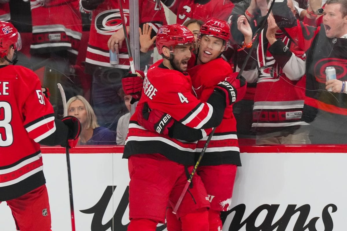 Feb 28, 2026; Raleigh, North Carolina, USA;  Carolina Hurricanes left wing Taylor Hall (71) celebrates his goal with  defenseman Shayne Gostisbehere (4) against the Detroit Red Wings during the first period at Lenovo Center. Mandatory Credit: James Guillory-Imagn Images