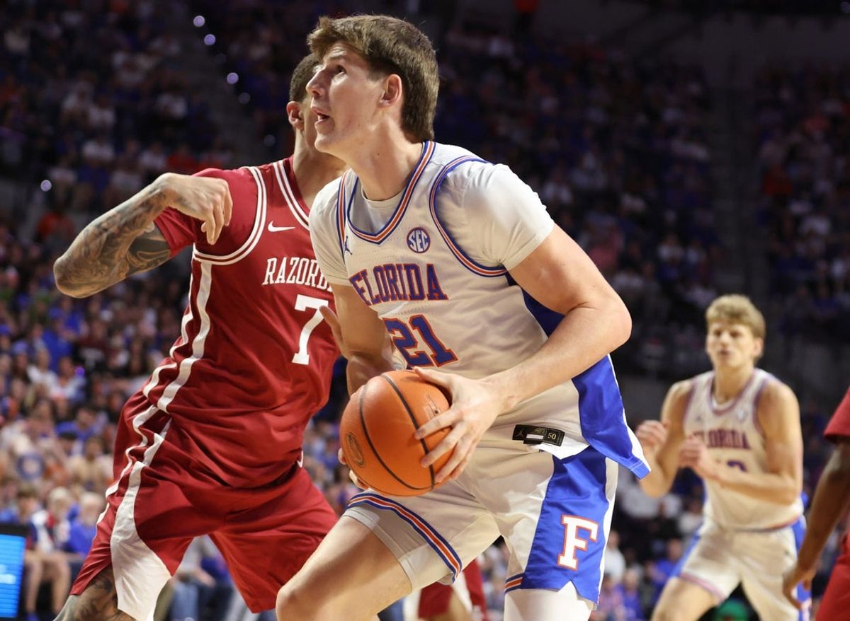 Florida forward Alex Condon (21) drives on Arkansas forward Trevon Brazile (7) during the first half of an NCAA basketball game at Steven C. O'Connell Center Exactek arena in Gainesville, FL on Saturday, February 28, 2026. [Alan Youngblood/Gainesville Sun]