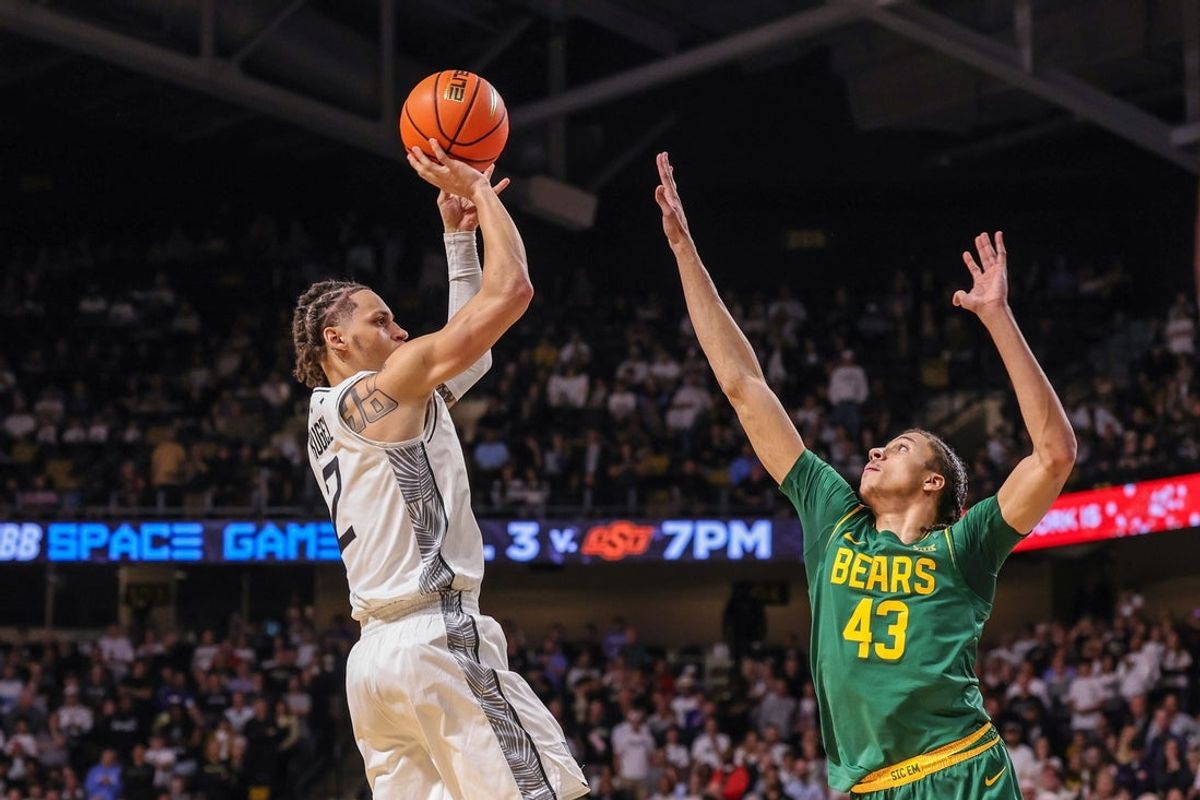 Feb 28, 2026; Orlando, Florida, USA; UCF Knights guard Riley Kugel (2) shoots against Baylor Bears guard Cameron Carr (43) during the first half at Addition Financial Arena. Mandatory Credit: Mike Watters-Imagn Images