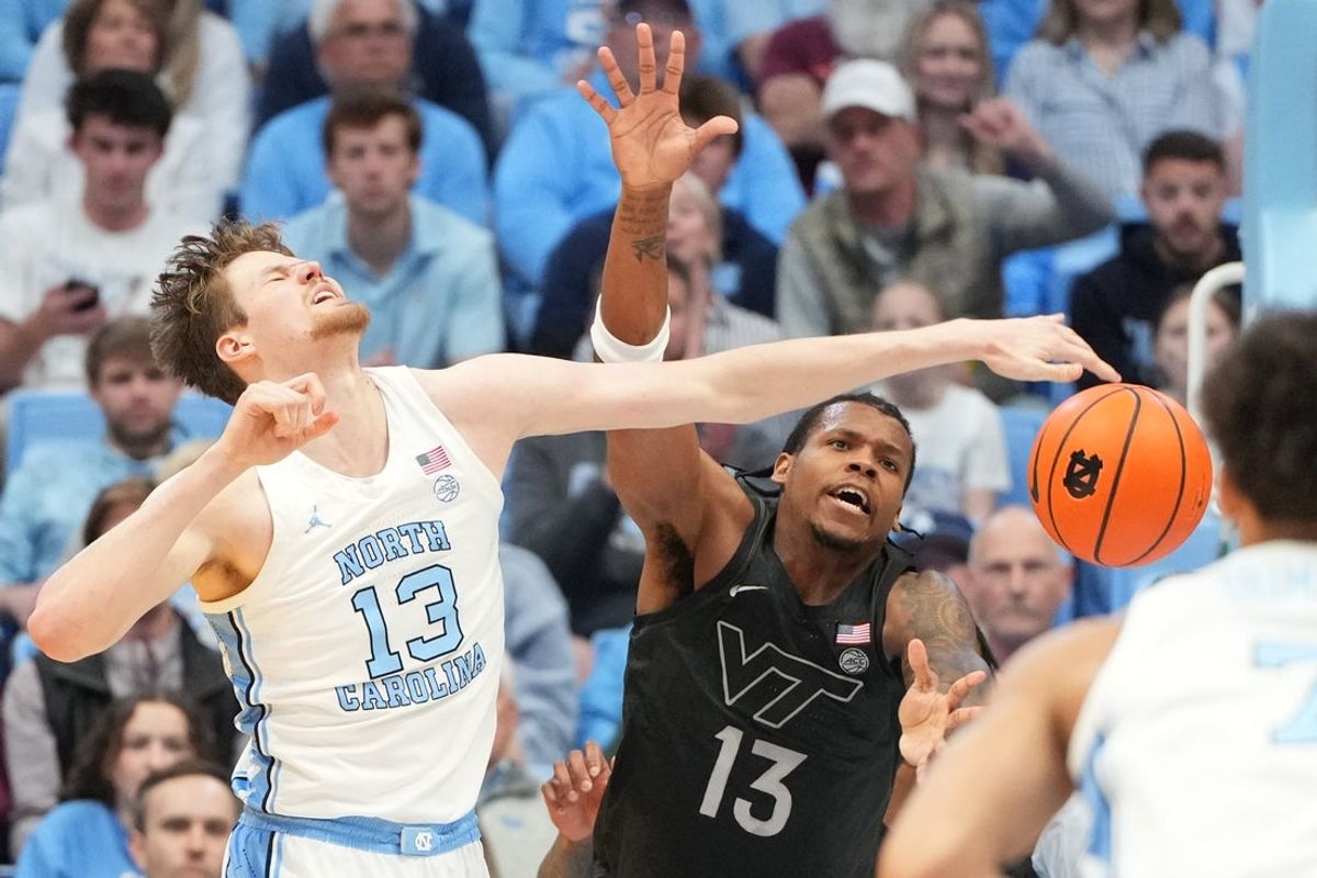 Feb 28, 2026; Chapel Hill, North Carolina, USA; North Carolina Tar Heels center Henri Veesaar (13) and Virginia Tech Hokies forward Amani Hansberry (13) fight for the ball in the first half at Dean E. Smith Center. Mandatory Credit: Bob Donnan-Imagn Images