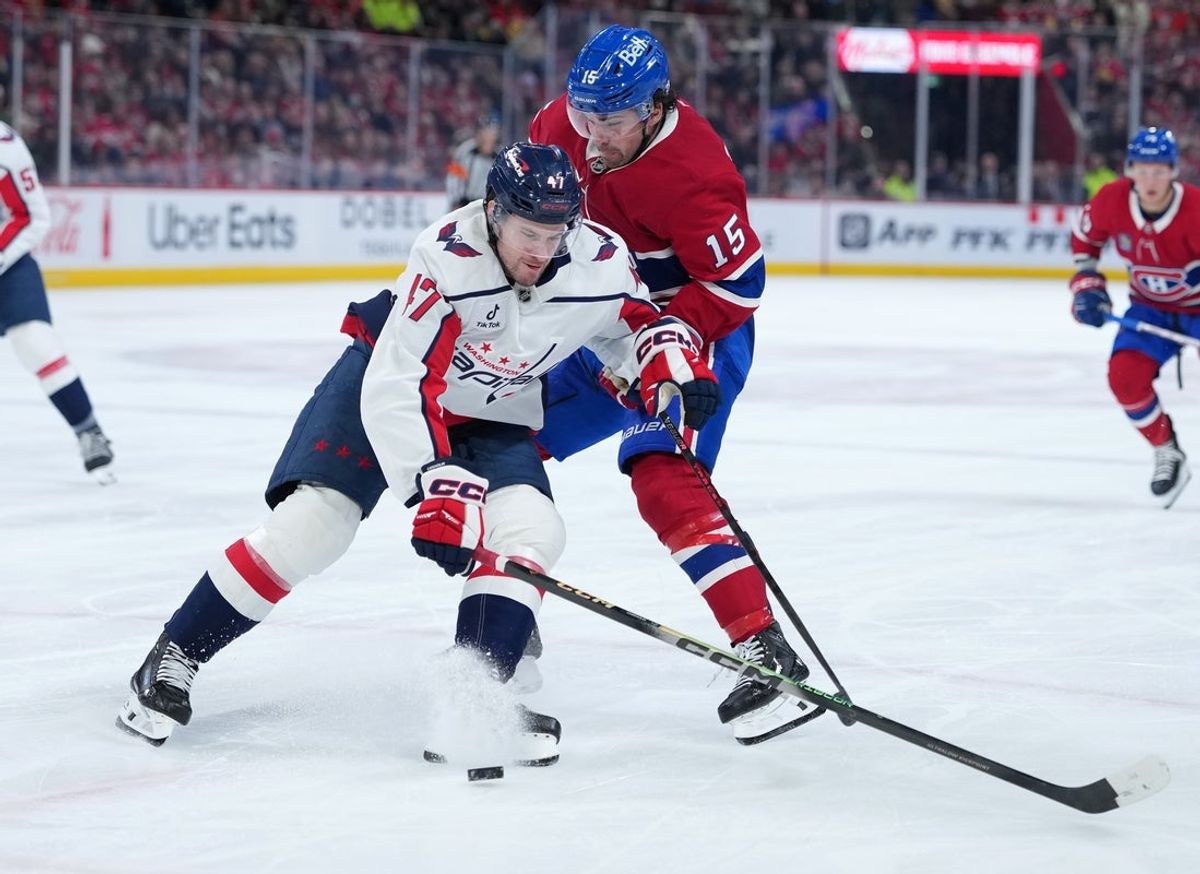 Feb 28, 2026; Montreal, Quebec, CAN; Montreal Canadiens forward Alex Newhook (15) goes by Washington Capitals forward Dylan Strome (17) during the second period at the Bell Centre. Mandatory Credit: Eric Bolte-Imagn Images