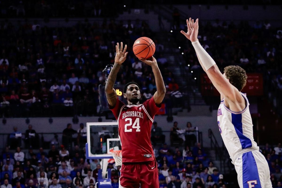 Feb 28, 2026; Gainesville, Florida, USA; Arkansas Razorbacks wing Billy Richmond III (24) shoots against Florida Gators guard Alex Kovatchev (8) during the first half at Exactech Arena at the Stephen C. O'Connell Center. Mandatory Credit: Travis Register-Imagn Images