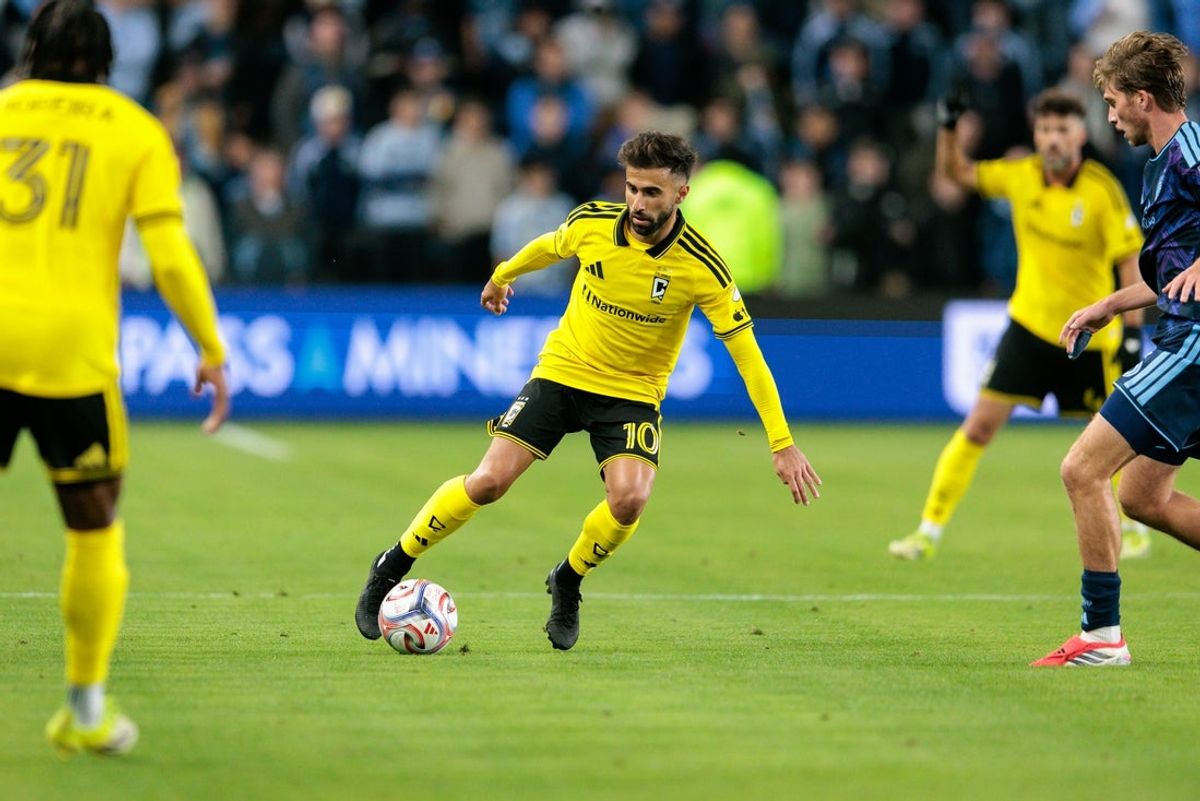 Feb 28, 2026; Kansas City, Kansas, USA; Columbus Crew midfielder Diego Rossi (10) brings the ball up field during the first half against the Sporting Kansas City at Children's Mercy Park. Mandatory Credit: William Purnell-Imagn Images