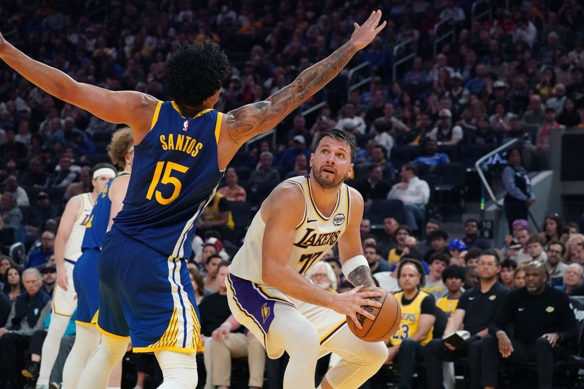 Feb 28, 2026; San Francisco, California, USA;  Los Angeles Lakers forward/guard Luka Doncic (77) is defended by Golden State Warriors forward Gui Santos (15) in the second period at Chase Center. Mandatory Credit: David Gonzales-Imagn Images