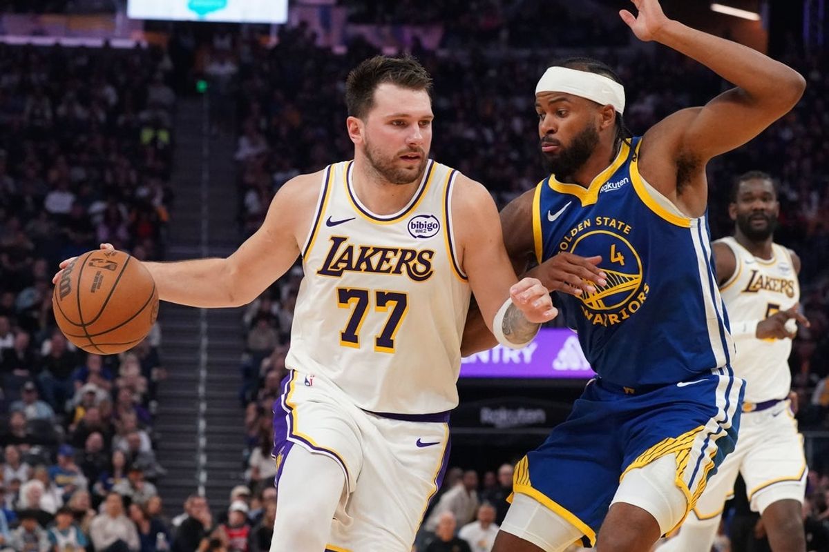 Feb 28, 2026; San Francisco, California, USA;  Los Angeles Lakers forward/guard Luka Doncic (77) dribbles against Golden State Warriors guard Moses Moody (4) in the second period at Chase Center. Mandatory Credit: David Gonzales-Imagn Images