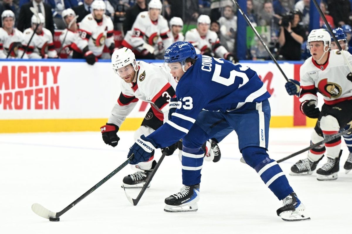 Feb 28, 2026; Toronto, Ontario, CAN;  Toronto Maple Leafs forward Easton Cowan (53) stickhandles the puck past Ottawa Senators defenseman Nick Jensen (3) in the third period at Scotiabank Arena. Mandatory Credit: Dan Hamilton-Imagn Images