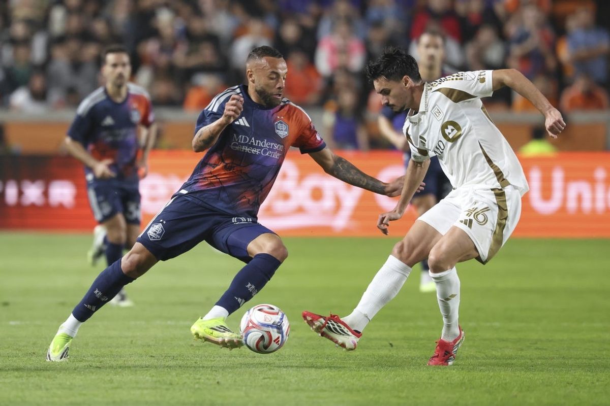 Feb 28, 2026; Houston, Texas, USA; Houston Dynamo FC forward Guilherme (20) and Los Angeles FC midfielder Stephen Eustaquio (46) battle for the ball during the second half at Shell Energy Stadium. Mandatory Credit: Troy Taormina-Imagn Images