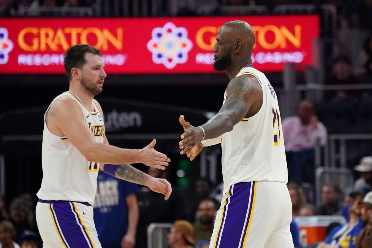 Feb 28, 2026; San Francisco, California, USA;  Los Angeles Lakers forward/guard Luka Doncic (77) and forward LeBron James (23) exchange high fives during a substitution against the Golden State Warriors in the third quarter at Chase Center. Mandatory Credit: David Gonzales-Imagn Images