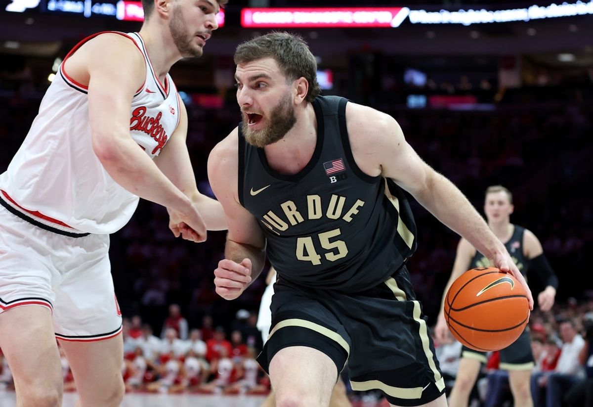 Mar 1, 2026; Columbus, Ohio, USA; Purdue Boilermakers center Oscar Cluff (45) drives to the basket as Ohio State Buckeyes center Ivan Njegovan (7) defends during the first half at Value City Arena. Mandatory Credit: Joseph Maiorana-Imagn Images
