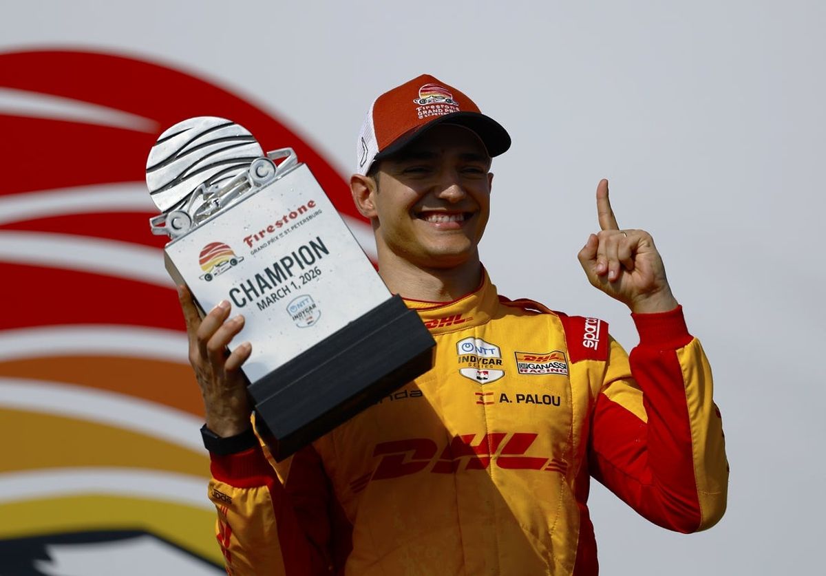 Mar 1, 2026; St. Petersburg, Florida, USA;  Chip Ganassi Racing driver Alex Palou (10) stands on the podium after winning the NTT Indycar Series at the Firestone Grand Prix on the Streets of St. Petersburg. Mandatory Credit: Russell Lansford-Imagn Images