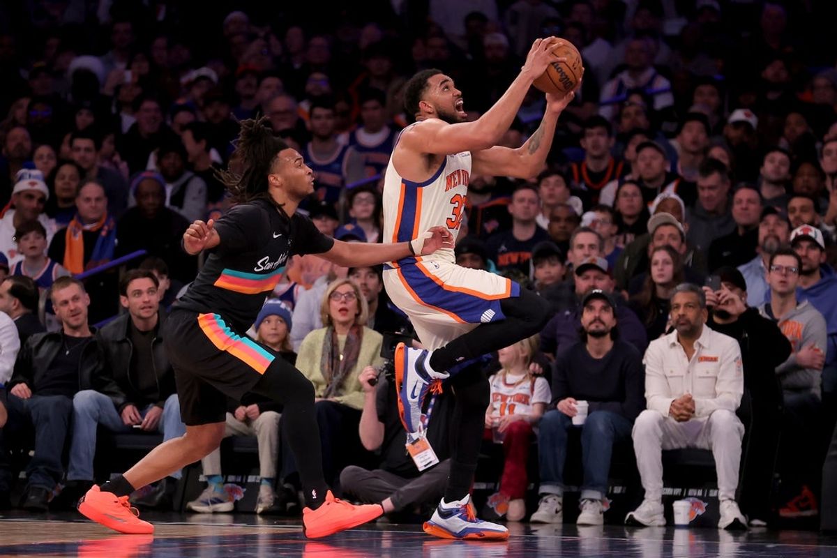 Mar 1, 2026; New York, New York, USA; New York Knicks center Karl-Anthony Towns (32) drives to the basket against San Antonio Spurs guard Stephon Castle (5) during the third quarter at Madison Square Garden. Mandatory Credit: Brad Penner-Imagn Images