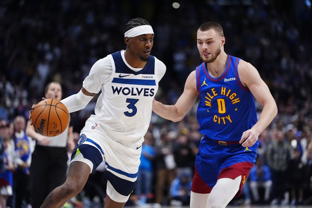 Mar 1, 2026; Denver, Colorado, USA; Denver Nuggets guard Christian Braun (0) defends on Minnesota Timberwolves forward Jaden McDaniels (3) in the first quarter at Ball Arena. Mandatory Credit: Ron Chenoy-Imagn Images
