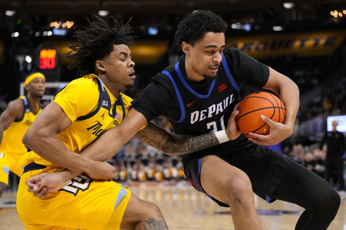 Mar 1, 2026; Milwaukee, Wisconsin, USA;  DePaul Blue Demons forward Theo Pierre-Justin (21) holds the ball away from Marquette Golden Eagles guard Nigel James Jr. (0) during the first half at Fiserv Forum. Mandatory Credit: Jeff Hanisch-Imagn Images
