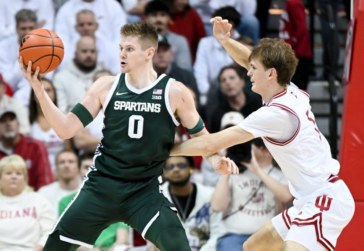 Mar 1, 2026; Bloomington, Indiana, USA; Michigan State Spartans forward Jaxon Kohler (0) dribbles against Indiana Hoosiers forward Reed Bailey (1) during the first half at Simon Skjodt Assembly Hall. Mandatory Credit: Robert Goddin-Imagn Images