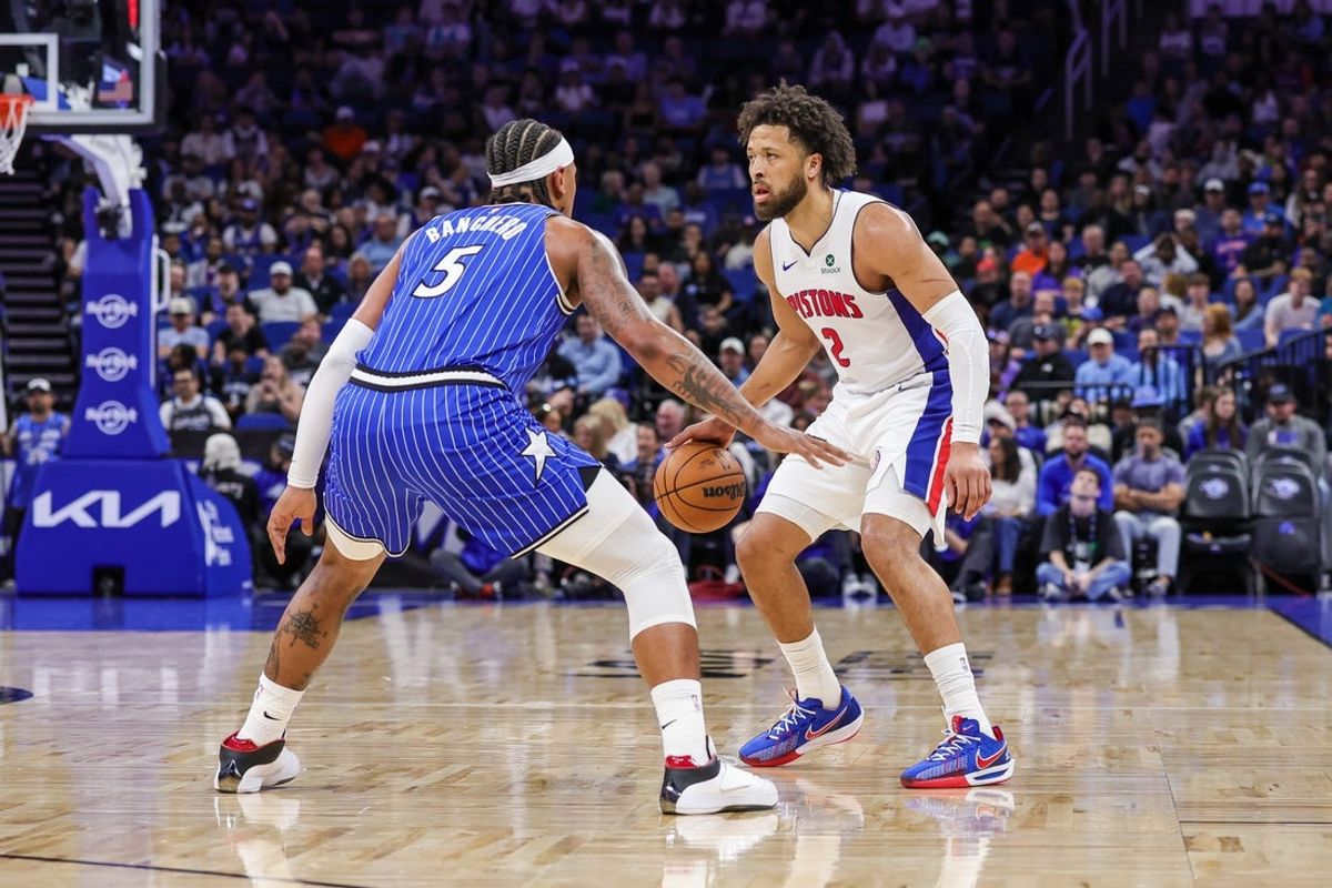 Mar 1, 2026; Orlando, Florida, USA; Detroit Pistons guard Cade Cunningham (2) handles the ball in front of Orlando Magic forward Paolo Banchero (5) during the first quarter at Kia Center. Mandatory Credit: Mike Watters-Imagn Images