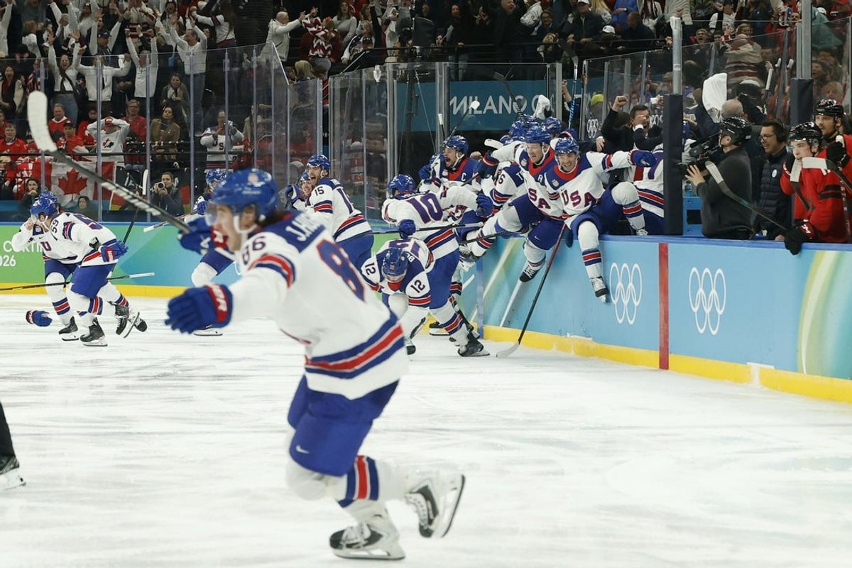 Feb 22, 2026; Milan, Italy; Team United States players celebrate after Jack Hughes (86) of Team United States scores the golden goal in overtime against Team Canada in the Gold Medal Game during the Milano Cortina 2026 Olympic Winter Games at Milano Santagiulia Ice Hockey Arena. Mandatory Credit: Geoff Burke-Imagn Images