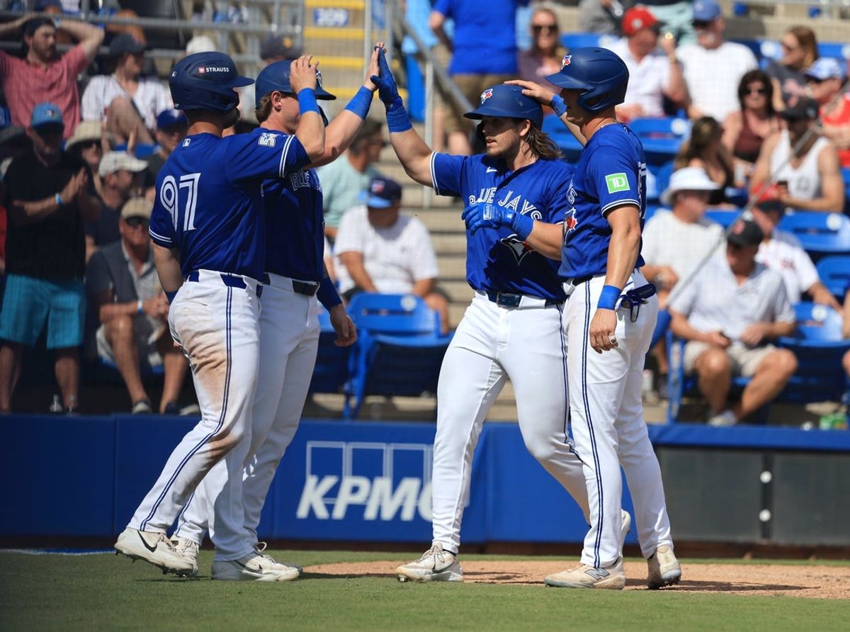Mar 2, 2026; Dunedin, Florida, USA;Toronto Blue Jays third baseman Addison Barger (47) is congratulated by third baseman Riley Tirotta (87) and teammates after he hit a grand slam during the fifth inning against the Boston Red Sox at TD Ballpark. Mandatory Credit: Kim Klement Neitzel-Imagn Images