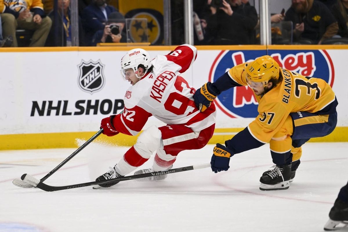 Mar 2, 2026; Nashville, Tennessee, USA;  Nashville Predators defenseman Nick Blankenburg (37) chases after Detroit Red Wings center Marco Kasper (92) during the third period at Bridgestone Arena. Mandatory Credit: Steve Roberts-Imagn Images