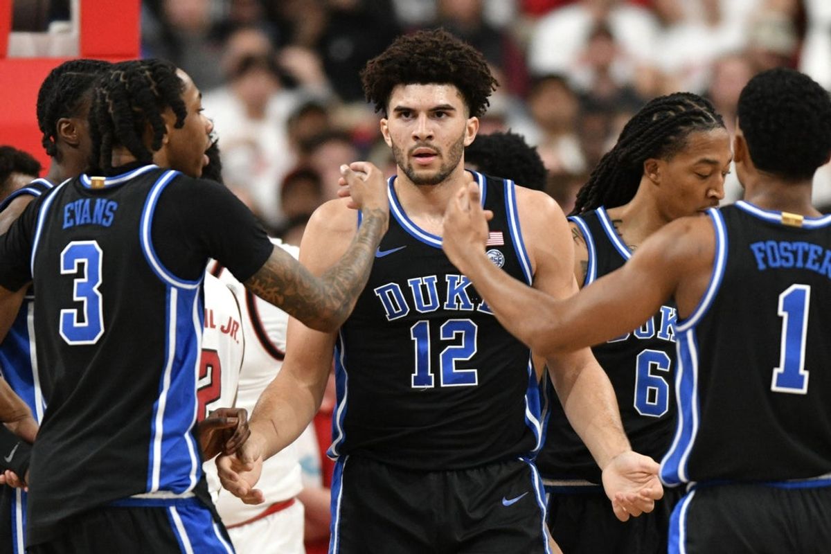Mar 2, 2026; Raleigh, North Carolina, USA;  Duke Blue Devils forward Cameron Boozer (12) reacts with guard Isaiah Evans (3) and guard Caleb Foster (1) after being fouled during the first half against the NC State Wolfpack at Lenovo Center. Mandatory Credit: Zachary Taft-Imagn Images