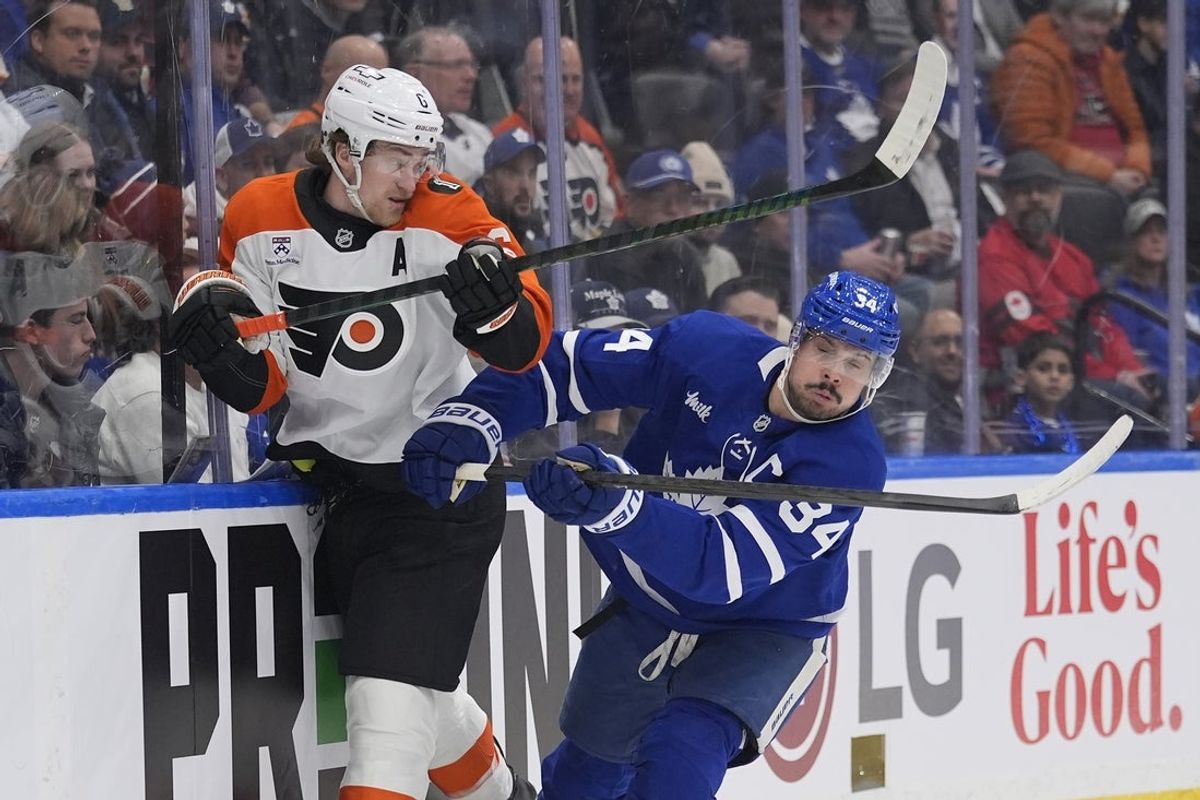 Mar 2, 2026; Toronto, Ontario, CAN; Toronto Maple Leafs forward Auston Matthews (34) checks Philadelphia Flyers defenseman Travis Sanheim (6) into the boards during the first period at Scotiabank Arena. Mandatory Credit: John E. Sokolowski-Imagn Images