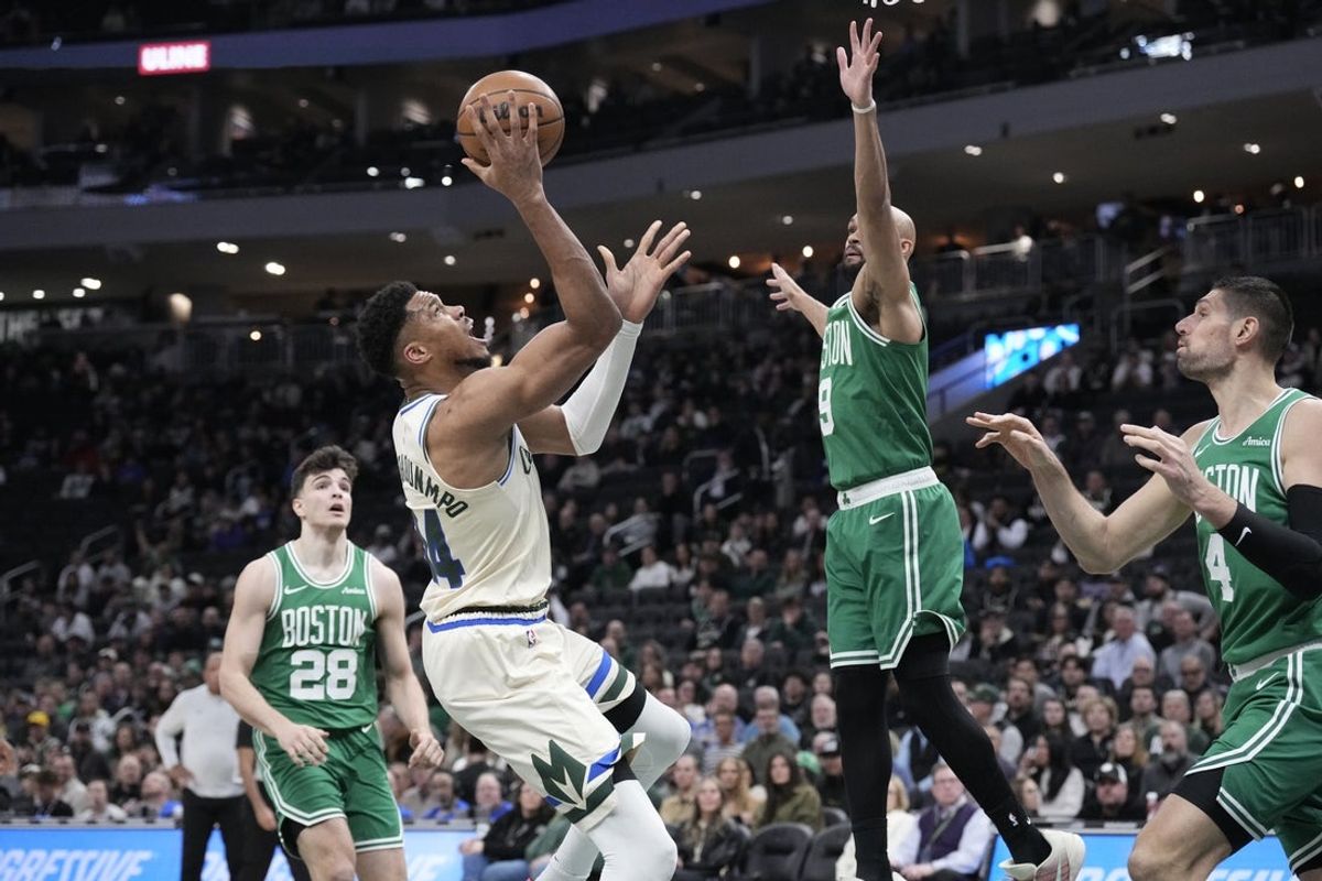 Mar 2, 2026; Milwaukee, Wisconsin, USA; Milwaukee Bucks forward Giannis Antetokounmpo (34) shoots against Boston Celtics guard Derrick White (9) in the first half at Fiserv Forum. Mandatory Credit: Michael McLoone-Imagn Images