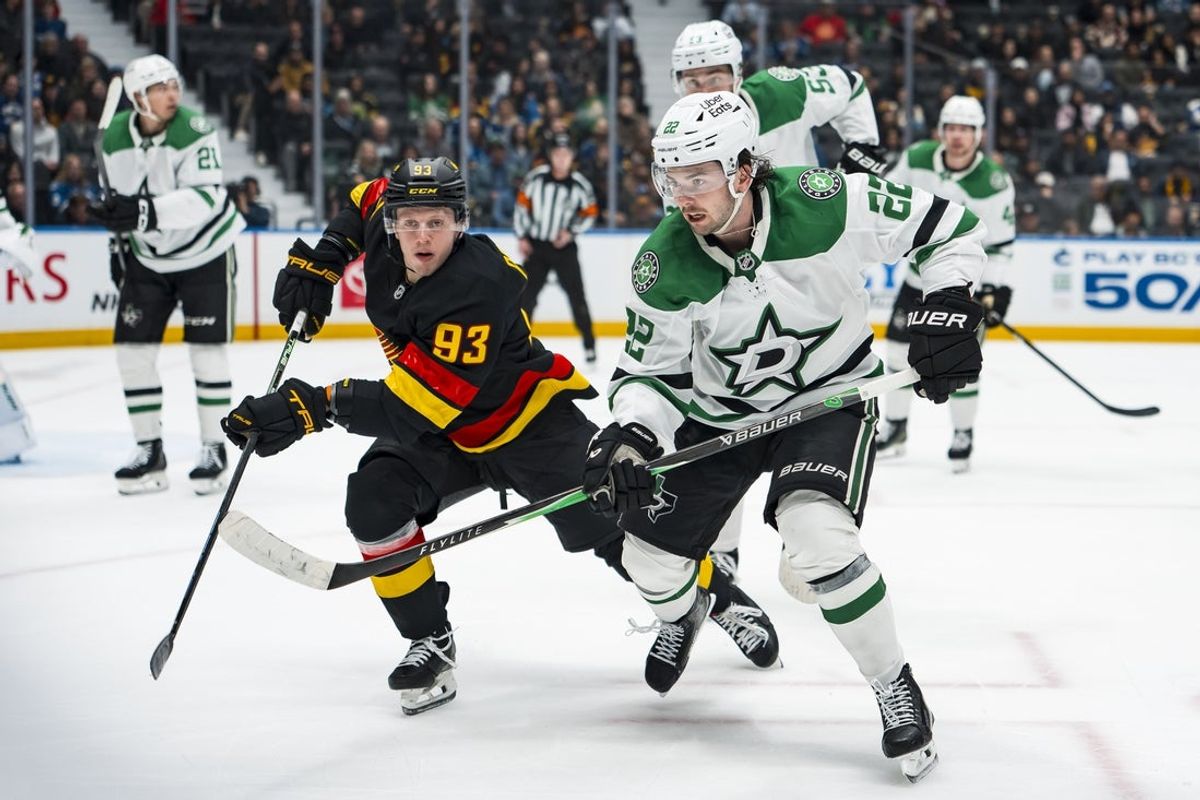 Mar 2, 2026; Vancouver, British Columbia, CAN; Vancouver Canucks forward Marco Rossi (93) and Dallas Stars forward Mavrik Bourque (22) skate after the loose puck in the second period at Rogers Arena. Mandatory Credit: Bob Frid-Imagn Images