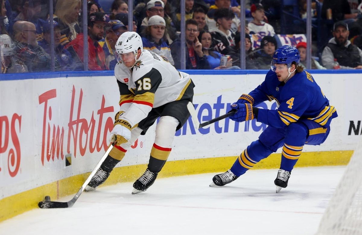 Mar 3, 2026; Buffalo, New York, USA;  Vegas Golden Knights right wing Pavel Dorofeyev (16) looks to control the puck as Buffalo Sabres defenseman Bowen Byram (4) defends during the first period at KeyBank Center. Mandatory Credit: Timothy T. Ludwig-Imagn Images