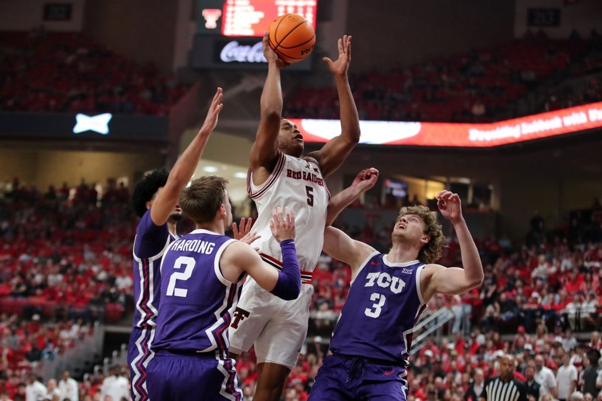 Mar 3, 2026; Lubbock, Texas, USA; Texas Tech Red Raiders forward Josiah Moseley (5) drives against TCU Horned Frogs guard Liutauras Lelevicius (3) and guard Brock Harding (2) in the first half at United Supermarkets Arena. Mandatory Credit: Michael C. Johnson-Imagn Images