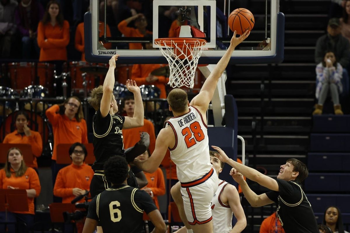 Mar 3, 2026; Charlottesville, Virginia, USA; Virginia Cavaliers forward Thijs de Ridder (28) shoots the ball as Wake Forest Demon Deacons guard Isaac Carr (7) defends in the first half at John Paul Jones Arena. Mandatory Credit: Geoff Burke-Imagn Images