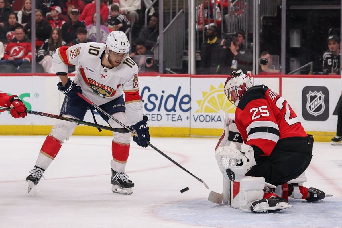 Mar 3, 2026; Newark, New Jersey, USA; New Jersey Devils goaltender Jacob Markstrom (25) makes a save on Florida Panthers left wing A.J. Greer (10) during the first period at Prudential Center. Mandatory Credit: Ed Mulholland-Imagn Images