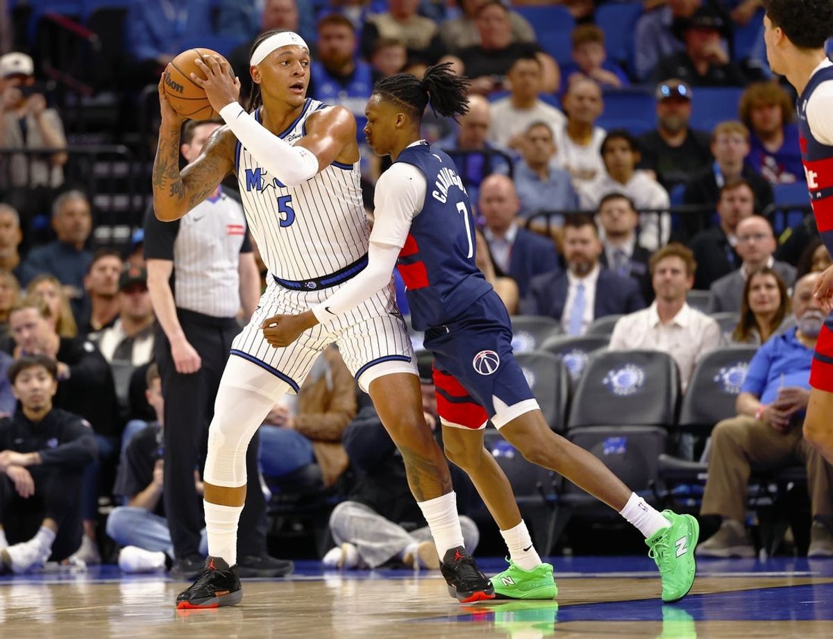 Mar 3, 2026; Orlando, Florida, USA;  Washington Wizards guard Bub Carrington (7) attempts to defend Orlando Magic forward Paolo Banchero (5)in the first half at Kia Center. Mandatory Credit: Russell Lansford-Imagn Images
