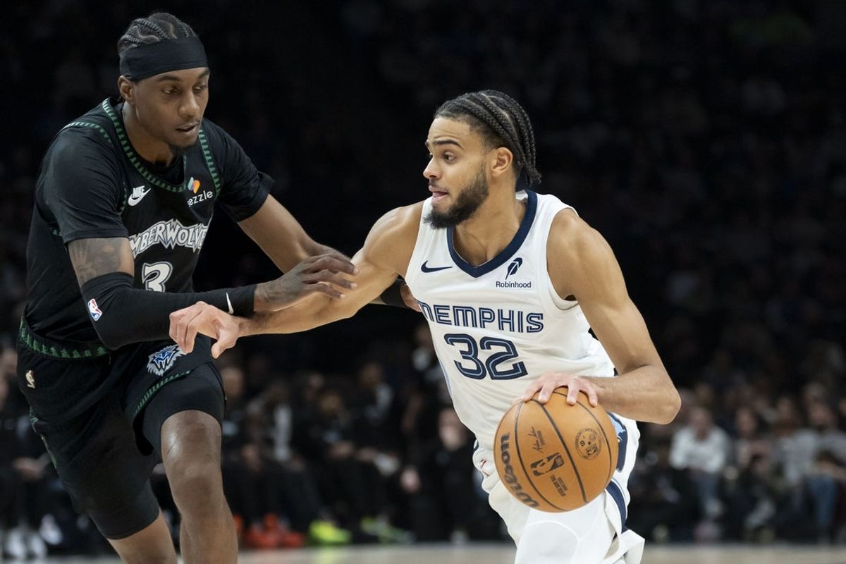 Mar 3, 2026; Minneapolis, Minnesota, USA; Memphis Grizzlies guard Rayan Rupert (32) dribbles the ball past Minnesota Timberwolves forward Jaden McDaniels (3) in the first half at Target Center. Mandatory Credit: Jesse Johnson-Imagn Images