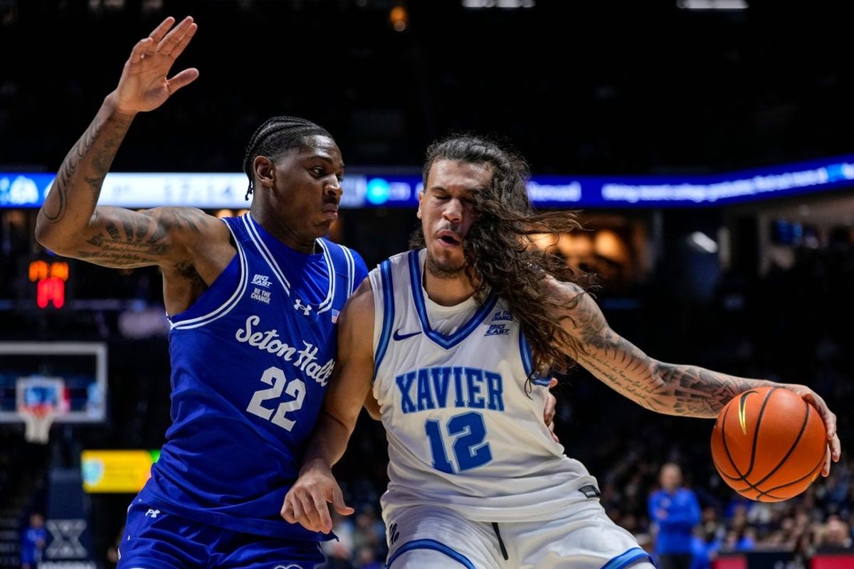Xavier Musketeers forward Tre Carroll (12) drives against Seton Hall Pirates guard Elijah Fisher (22) in the first half of the NCAA Big East conference basketball game between the Xavier Musketeers and the Seton Hall Pirates at the Cintas Center in Cincinnati on Tuesday, March 3, 2026. Xavier trailed 33-32 at halftime.