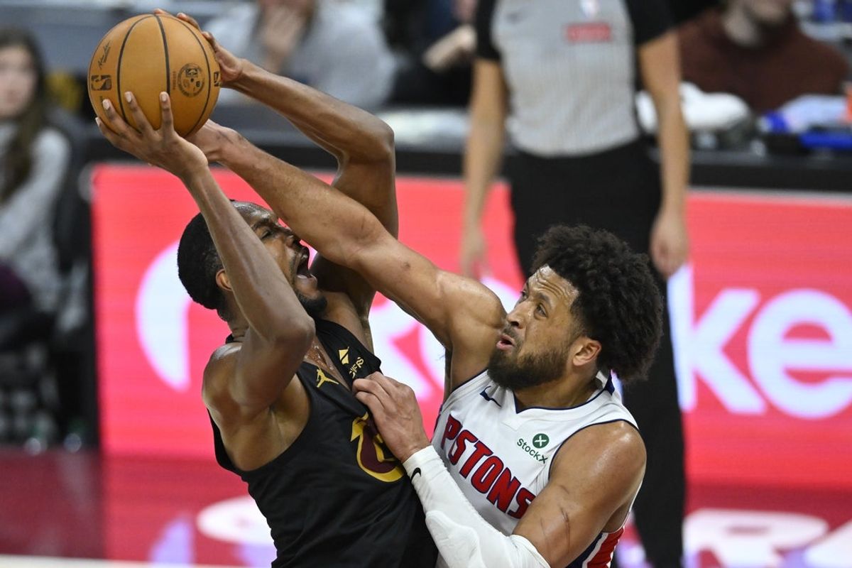 Mar 3, 2026; Cleveland, Ohio, USA; Cleveland Cavaliers center Evan Mobley (4) shoots beside Detroit Pistons guard Cade Cunningham (2) in the fourth quarter at Rocket Arena. Mandatory Credit: David Richard-Imagn Images