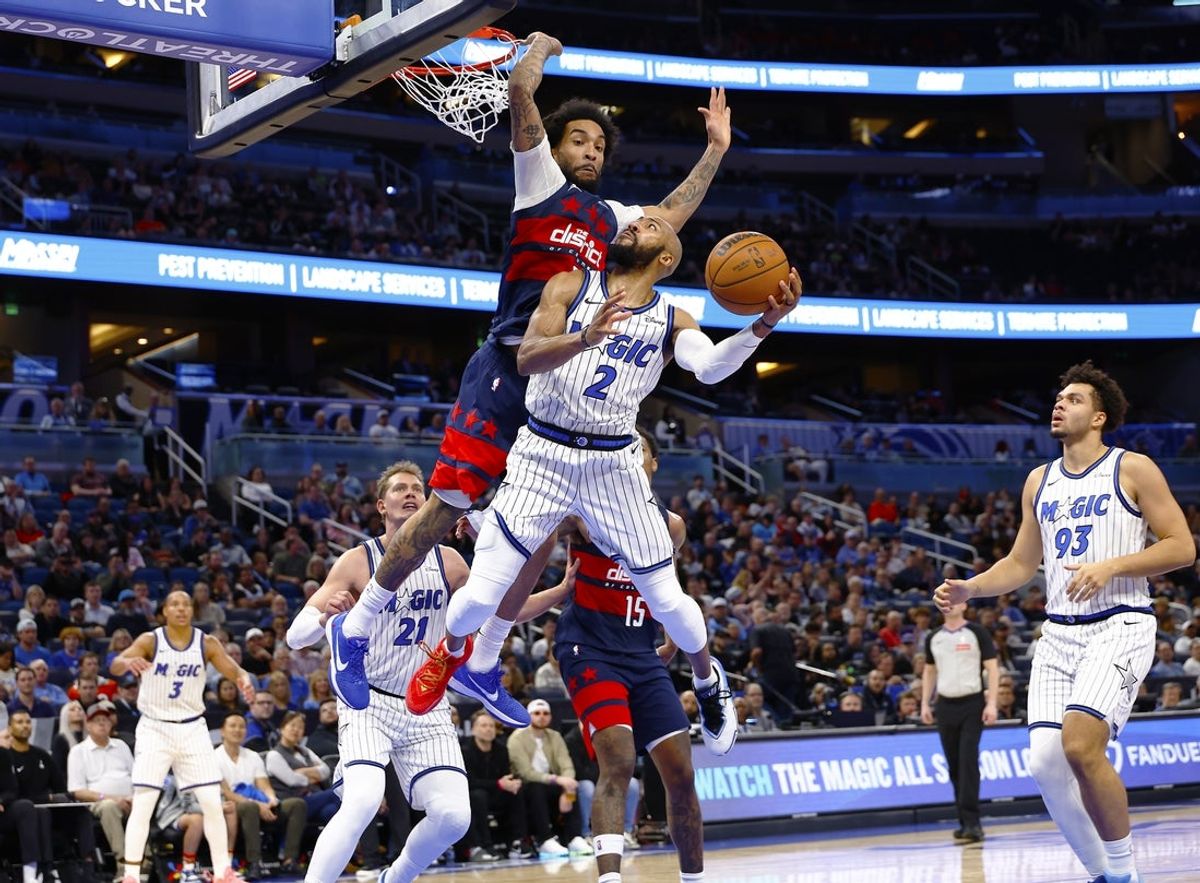 Mar 3, 2026; Orlando, Florida, USA;  Orlando Magic guard Jevon Carter (2) goes up for a shot as Washington Wizards forward Justin Champagnie (9) defends in the second half at Kia Center. Mandatory Credit: Russell Lansford-Imagn Images