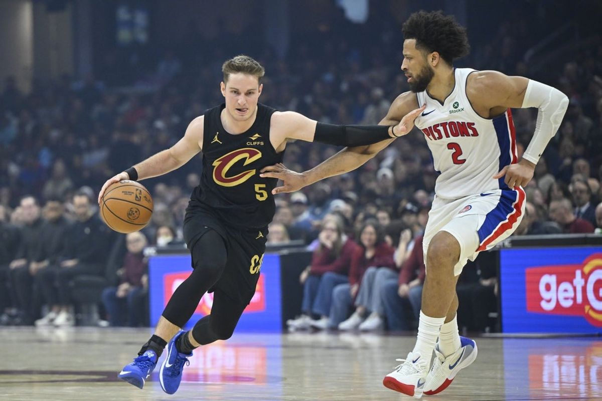Mar 3, 2026; Cleveland, Ohio, USA; Cleveland Cavaliers guard Sam Merrill (5) dribbles beside Detroit Pistons guard Cade Cunningham (2) in the third quarter at Rocket Arena. Mandatory Credit: David Richard-Imagn Images