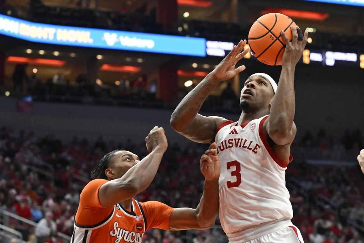 Mar 3, 2026; Louisville, Kentucky, USA;  Louisville Cardinals guard Ryan Conwell (3) shoots against Syracuse Orange guard JJ Starling (2) during the first half at KFC Yum! Center. Mandatory Credit: Jamie Rhodes-Imagn Images