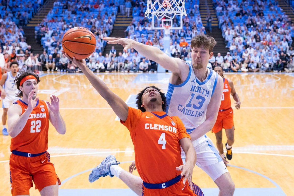 Mar 3, 2026; Chapel Hill, North Carolina, USA; Clemson Tigers guard Efrem Johnson (4) shoots against North Carolina Tar Heels center Henri Veesaar (13) during the first half at Dean E. Smith Center. Mandatory Credit: Scott Kinser-Imagn Images