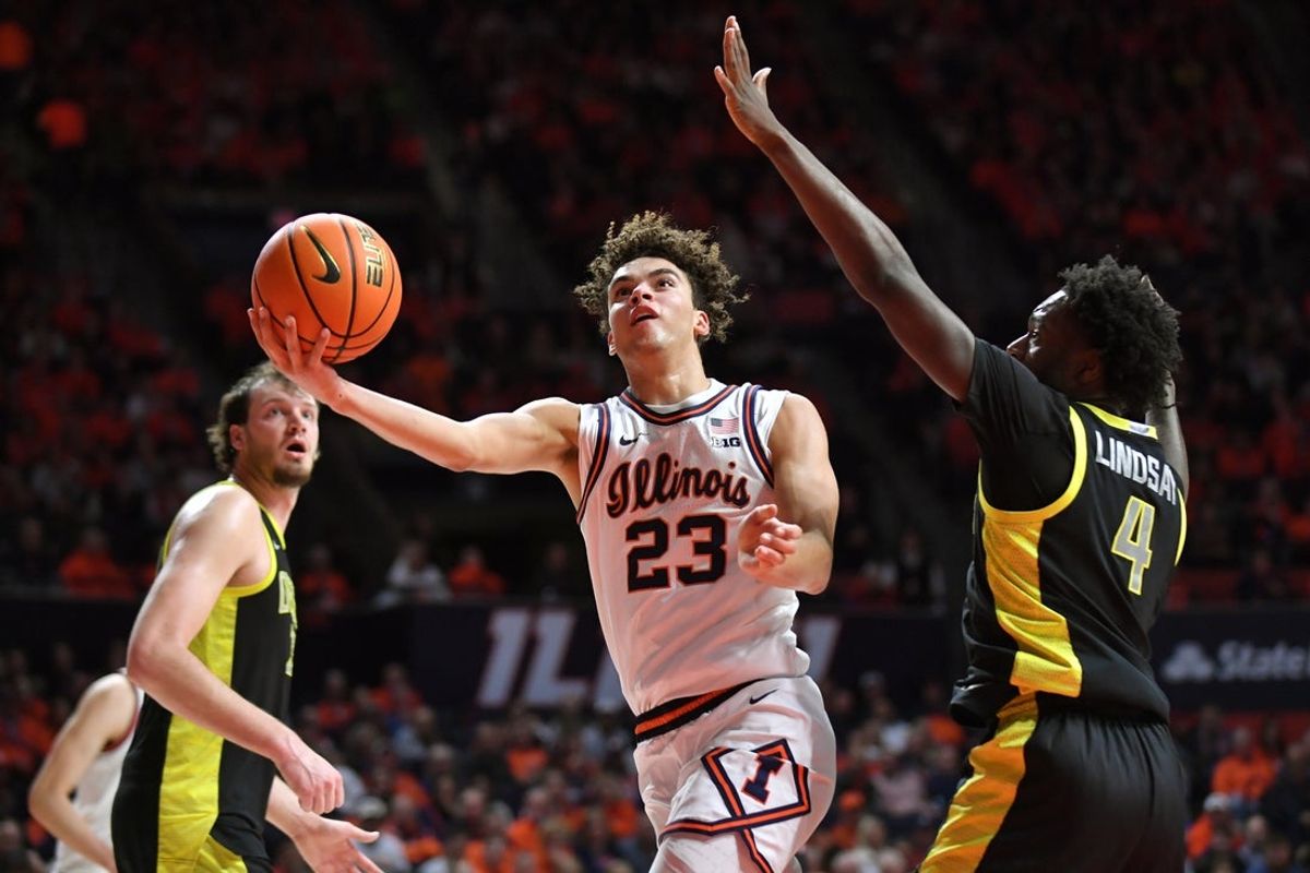 Mar 3, 2026; Champaign, Illinois, USA; Illinois Fighting Illini guard Keaton Wagler (23) drives past Oregon Ducks forward Dezdrick Lindsay (4) during the first half at State Farm Center. Mandatory Credit: Ron Johnson-Imagn Images