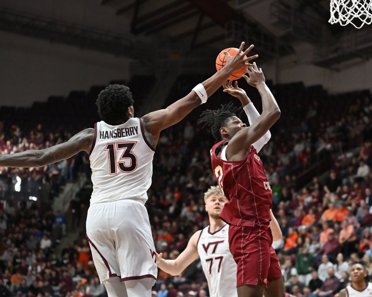 Mar 3, 2026; Blacksburg, Virginia, USA; Boston College Eagles forward Jayden Hastings (22) shoots a shot as Virginia Tech Hokies forward Amani Hansberry (13) defends  during the first half at Cassell Coliseum. Mandatory Credit: Brian Bishop-Imagn Images