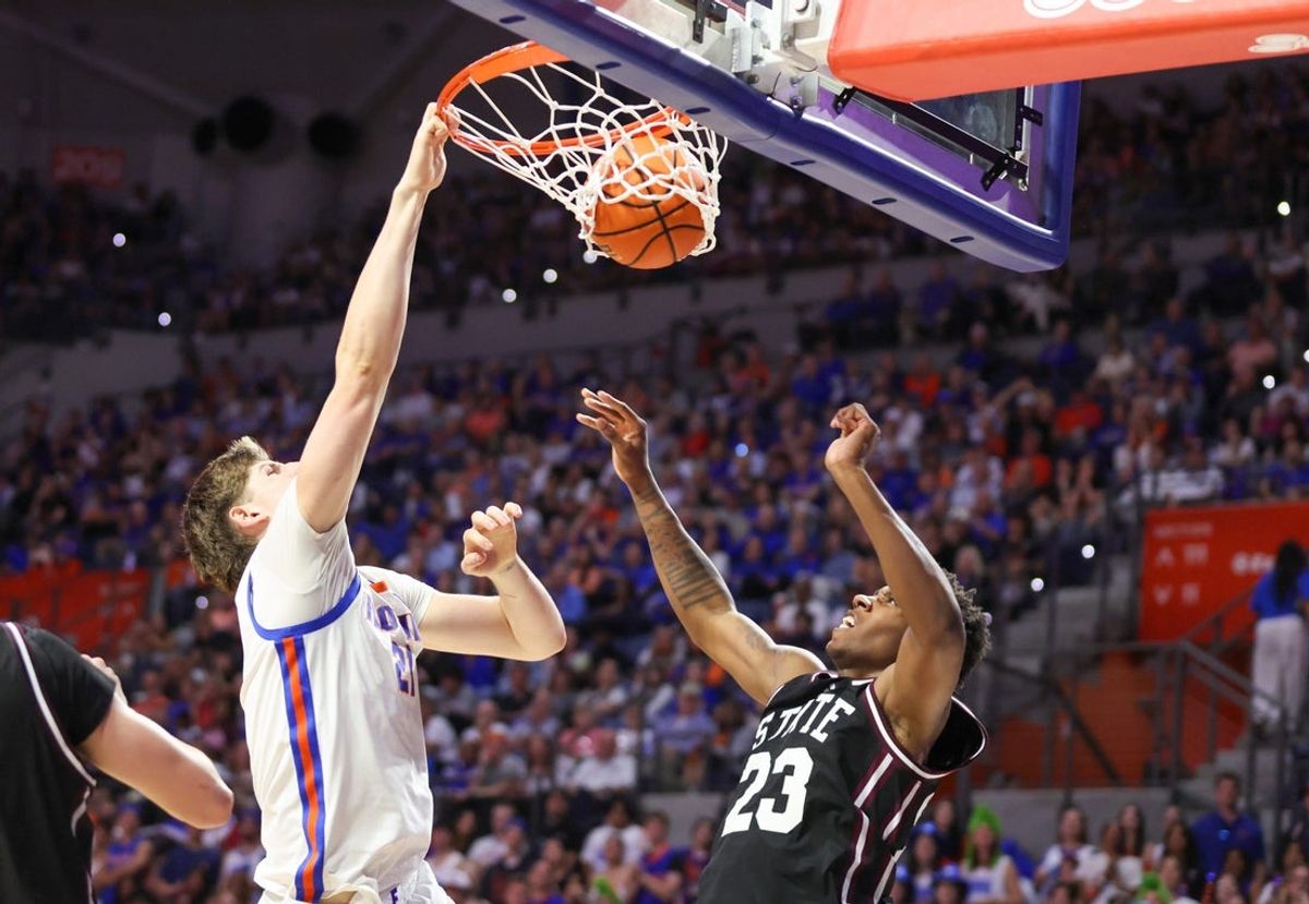 Florida forward Alex Condon (21) dunks under pressure from Mississippi State guard King Grace (23) during the second half of an NCAA mens basketball game at Steven C. O'Connell Center Exactek arena in Gainesville, FL on Tuesday, March 3, 2026. [Alan Youngblood/Gainesville Sun]