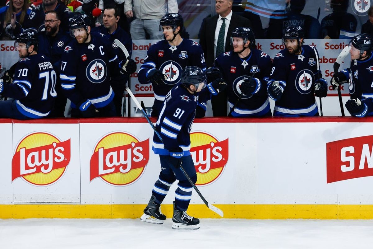 Mar 3, 2026; Winnipeg, Manitoba, CAN;  Winnipeg Jets forward Cole Perfetti (91) is congratulated after scoring against the Chicago Blackhawks during the third period at Canada Life Centre. Mandatory Credit: Terrence Lee-Imagn Images