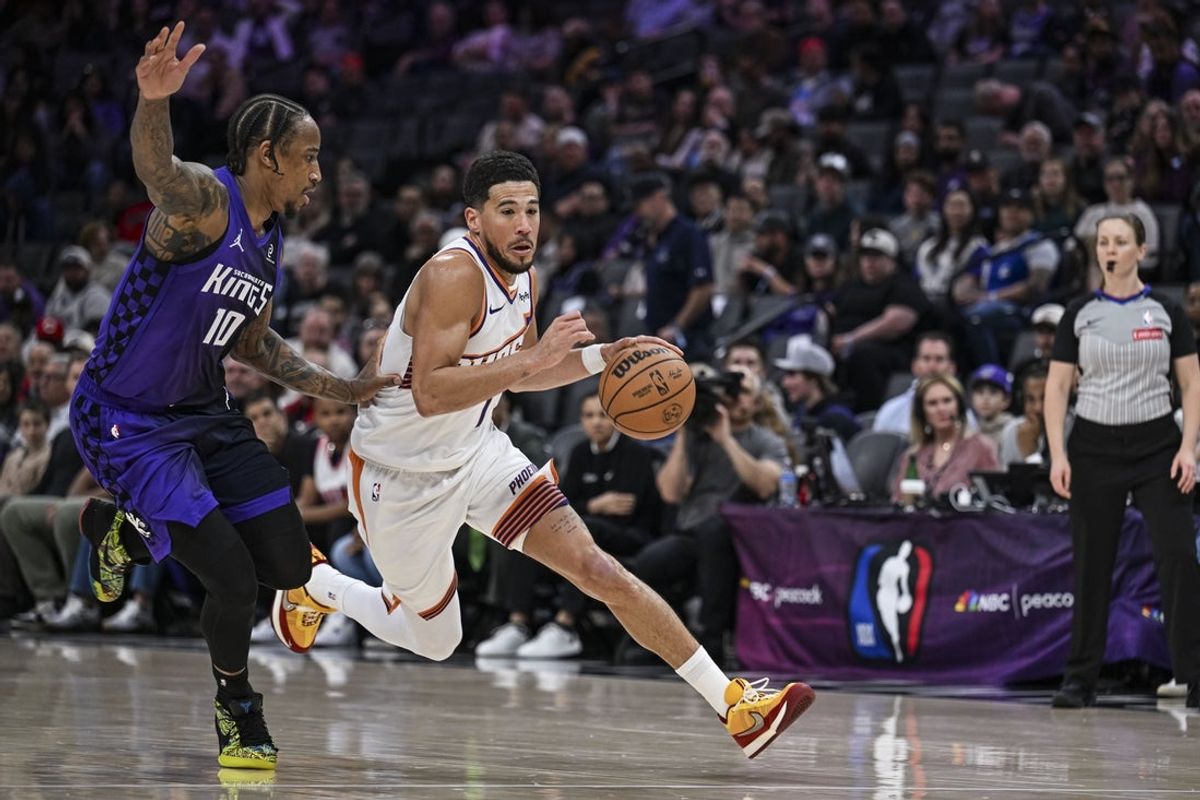 Mar 3, 2026; Sacramento, California, USA; Phoenix Suns guard Devin Booker (1) dribbles past Sacramento Kings guard DeMar DeRozan (10) during the second quarter at Golden 1 Center. Mandatory Credit: Justine Willard-Imagn Images