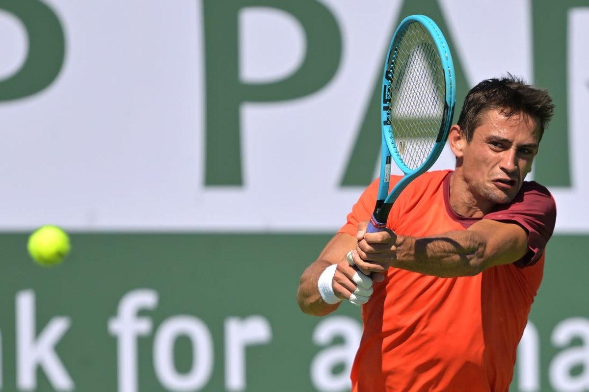 Mar 4, 2026; Indian Wells, CA, USA; Mariano Navone (ARG) hits a shot against Marcos Giron (USA) in his first round match during the BNP Paribas Open at the Indian Wells Tennis Garden. Mandatory Credit: Jayne Kamin-Oncea-Imagn Images
