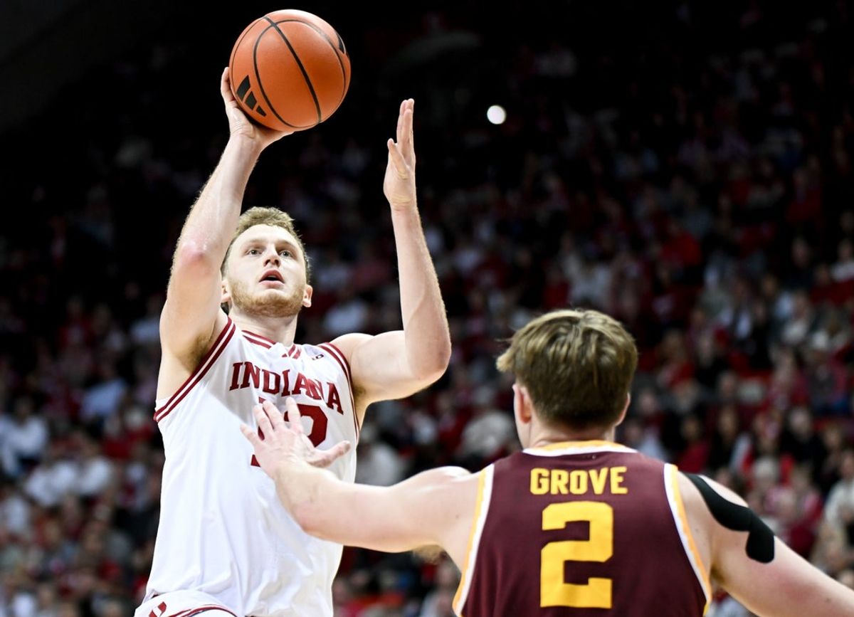 Mar 4, 2026; Bloomington, Indiana, USA; Indiana Hoosiers forward Tucker DeVries (12) shoots over Minnesota Golden Gophers forward Grayson Grove (2) during the first half at Simon Skjodt Assembly Hall. Mandatory Credit: Robert Goddin-Imagn Images